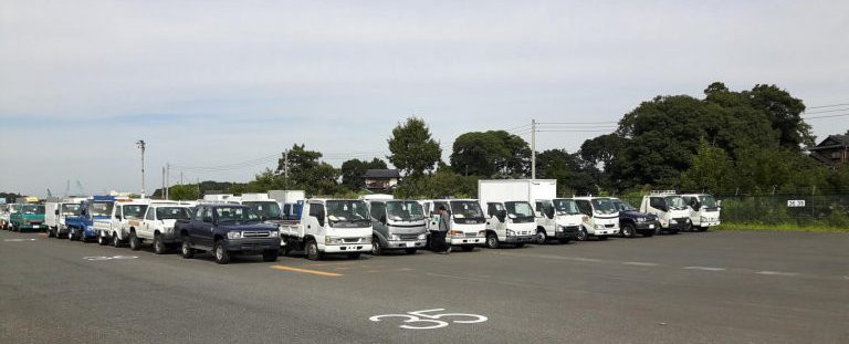 JDM Co., Ltd at USS Tokyo Auto Auction checking trucks and vans